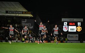 Grimsby Town players celebrate their win over Manchester United.
