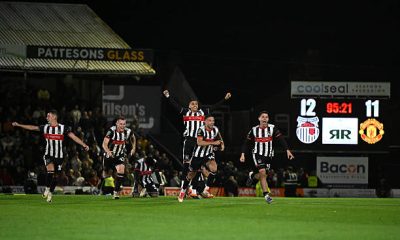 Grimsby Town players celebrate their win over Manchester United.