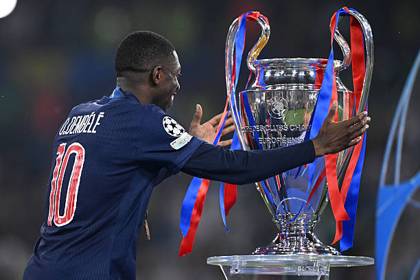 Ousmane Dembele and the Champions League trophy.